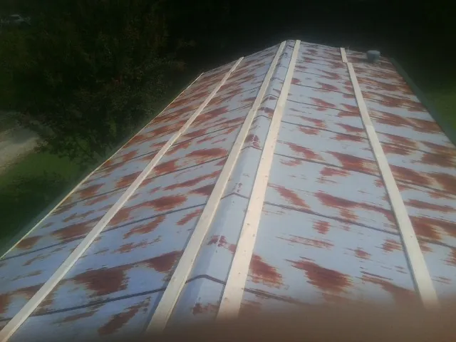 Rusted metal roof panels with new wood purlins before replacement — Storm Damage Roof Repair in Lynn Haven by Roofing Brothers